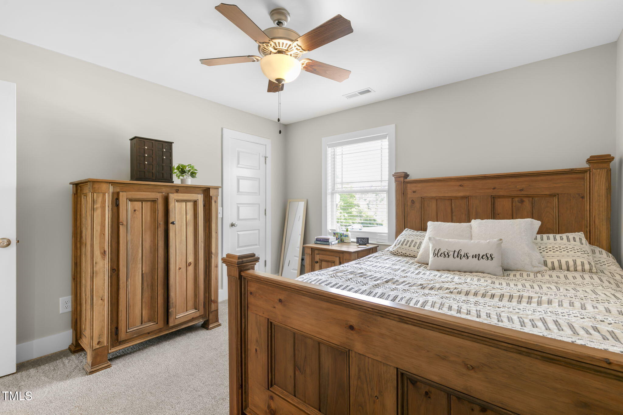 355 South Church Street Coats, NC 27521 - Photo 19 of 29 a bedroom with a large bed and a chandelier