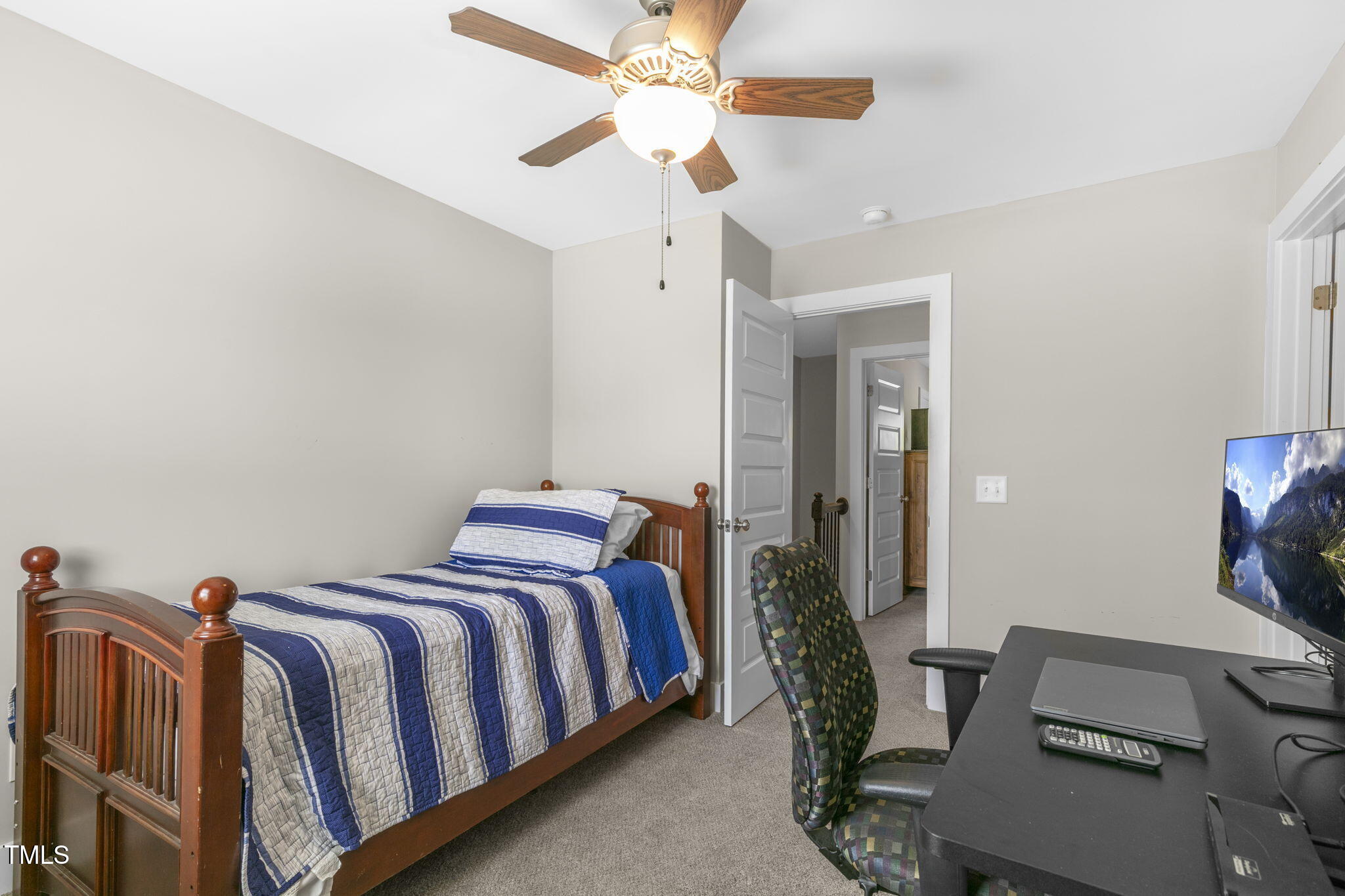 355 South Church Street Coats, NC 27521 - Photo 22 of 29 a bedroom with a bed and a chandelier