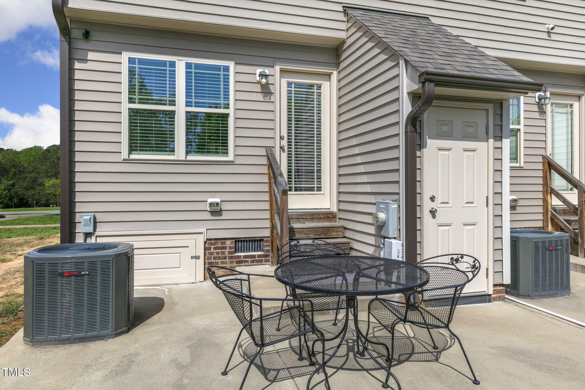 355 South Church Street Coats, NC 27521 - Photo 28 of 29 a patio with table and chairs and potted plants