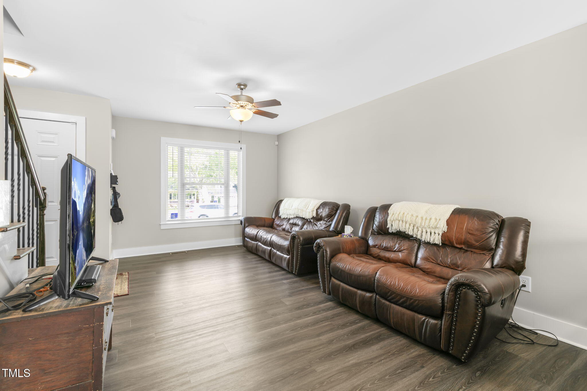 355 South Church Street Coats, NC 27521 - Photo 5 of 29 a living room with furniture a flat screen tv and a window