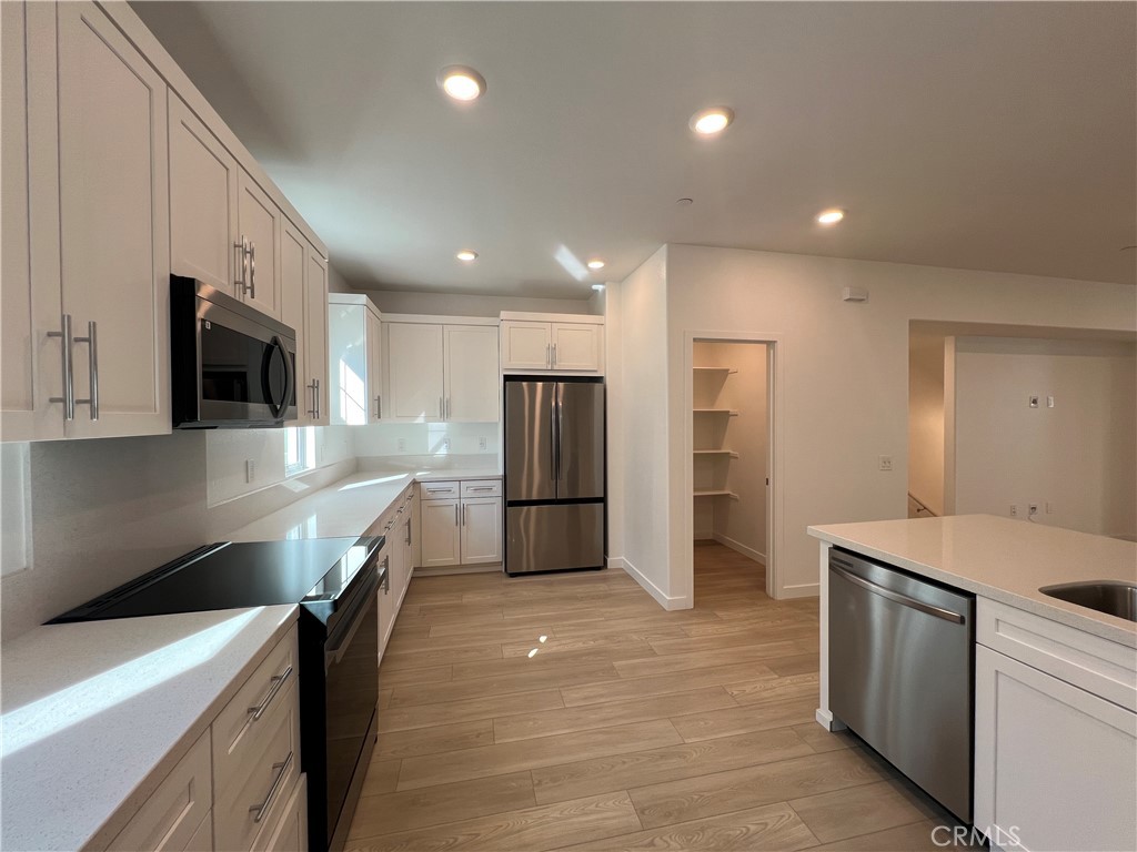 2544 Dorris Street El Monte, CA 91733 - Photo 5 of 13 a kitchen with a sink stainless steel appliances and cabinets