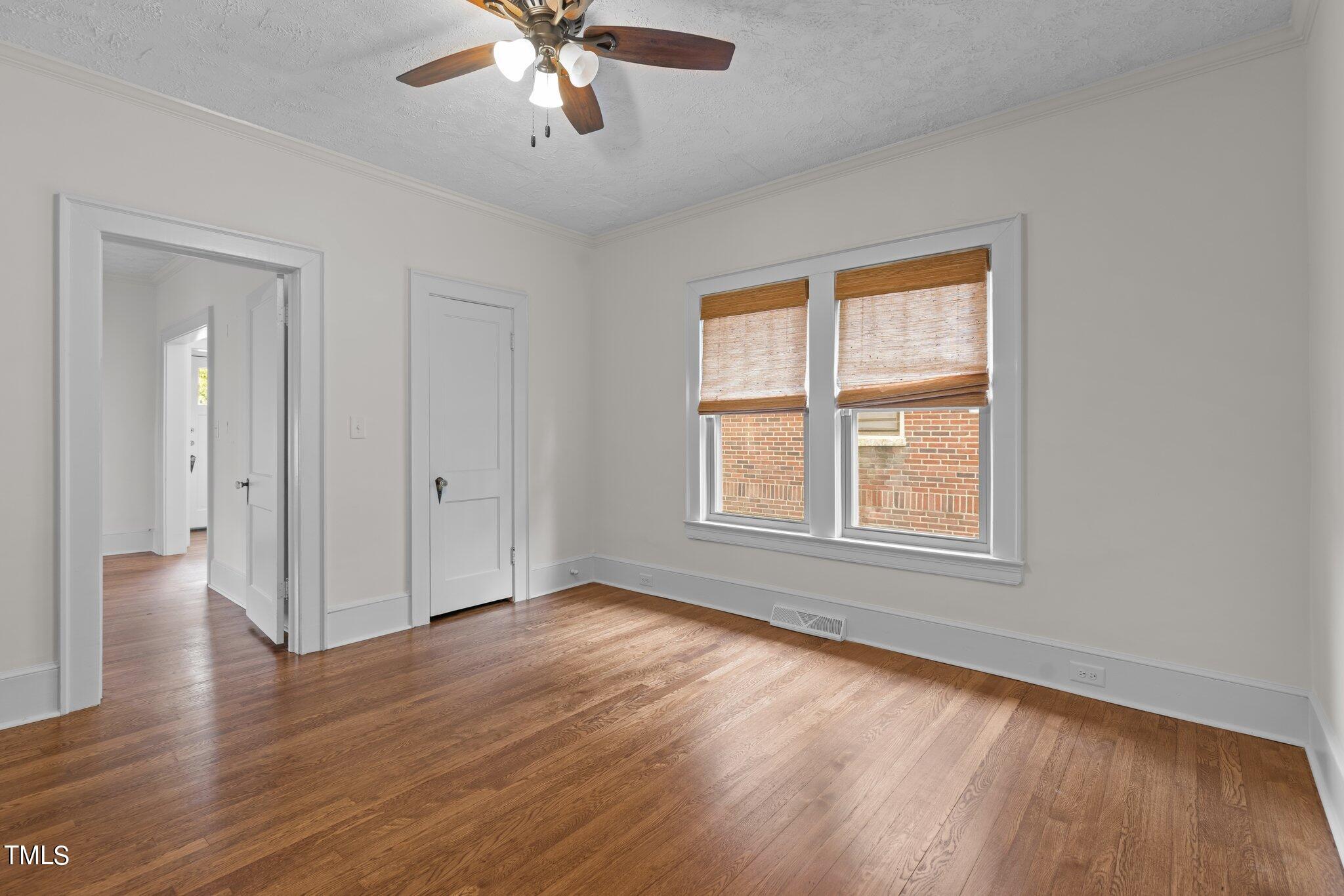501 South Main Street Roxboro, NC 27573 - Photo 16 of 30 a view of an empty room with wooden floor and a window