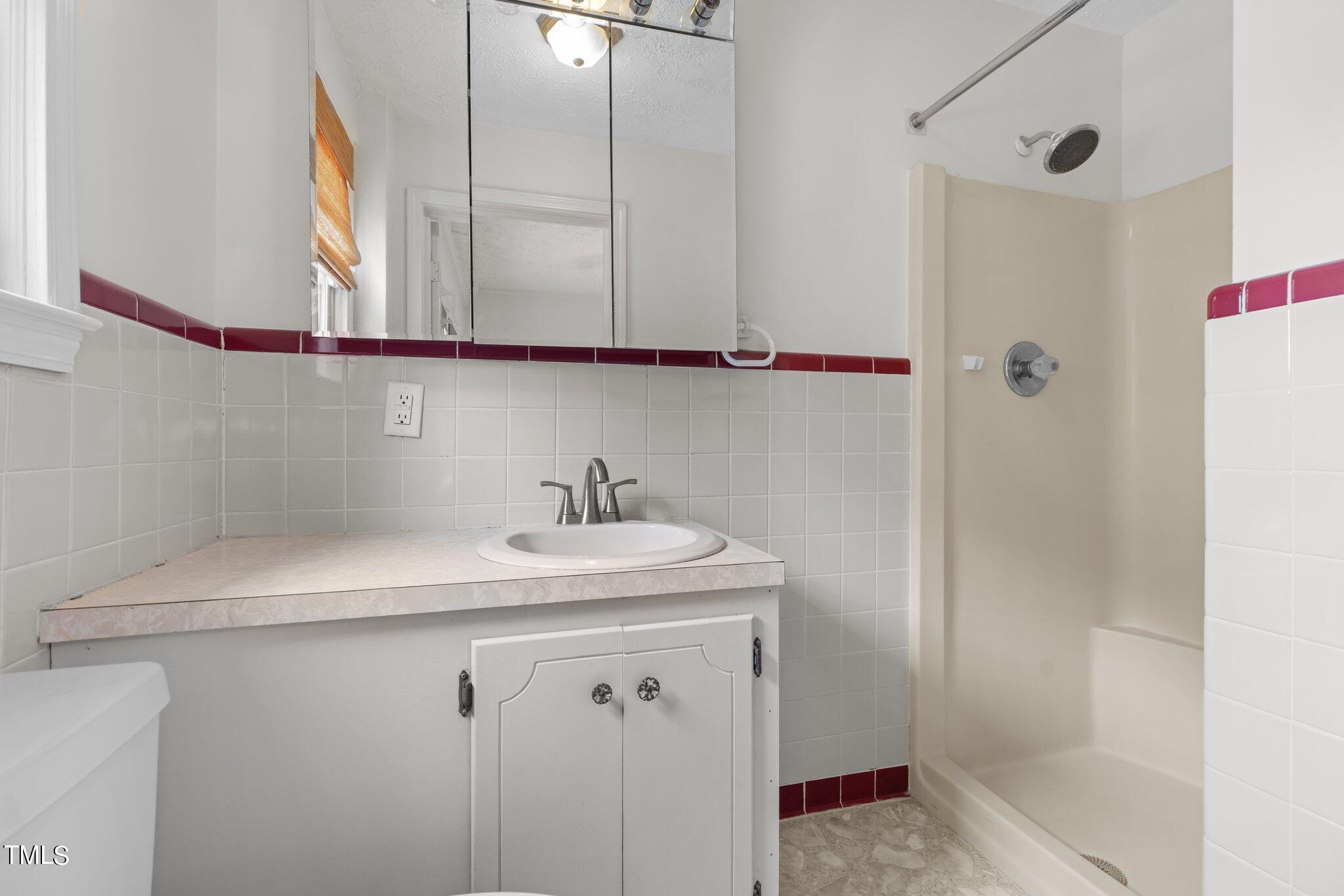501 South Main Street Roxboro, NC 27573 - Photo 25 of 30 a bathroom with a sink and a mirror