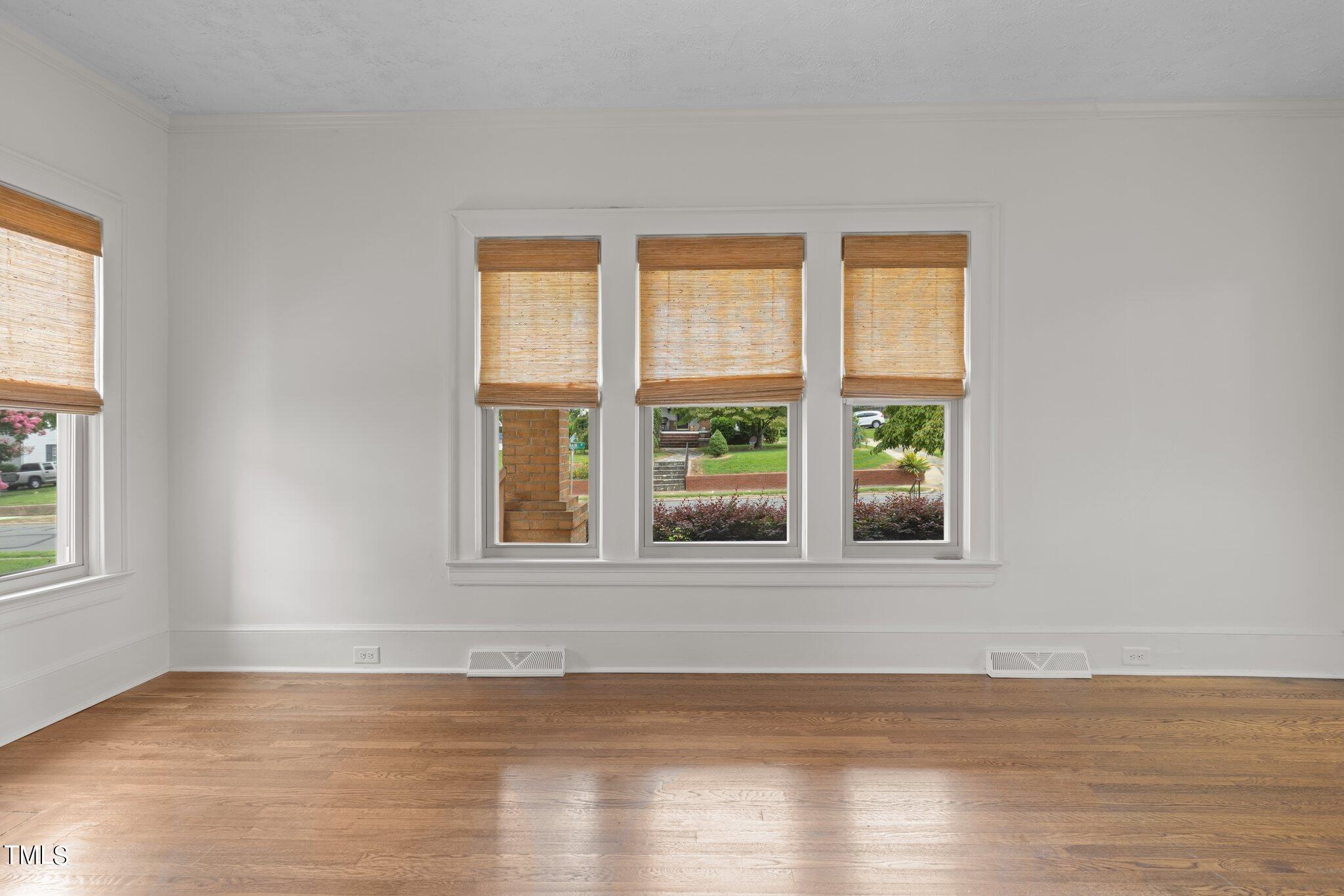 501 South Main Street Roxboro, NC 27573 - Photo 7 of 30 a view of an empty room with wooden floor and a window