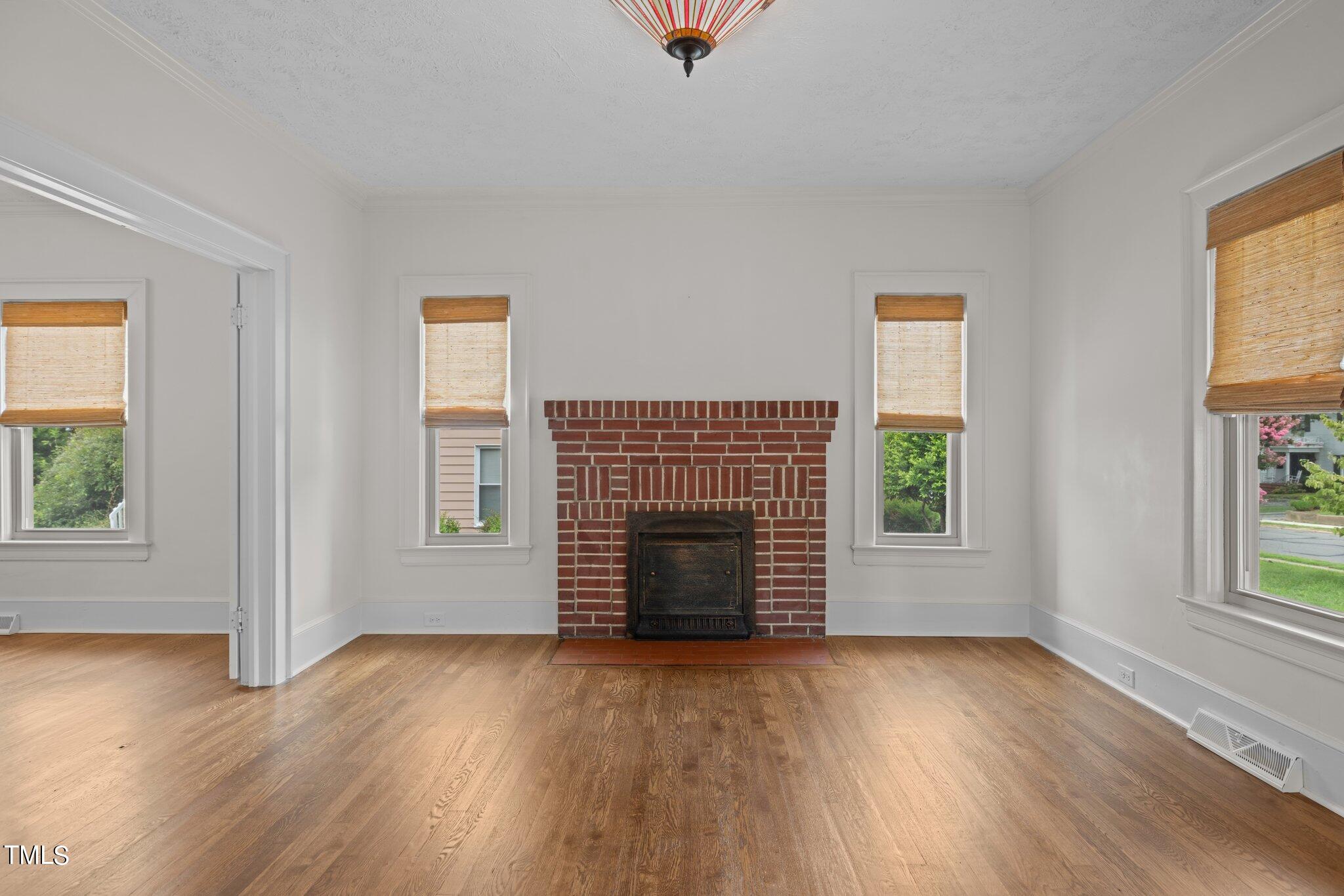 501 South Main Street Roxboro, NC 27573 - Photo 8 of 30 an empty room with windows and fireplace
