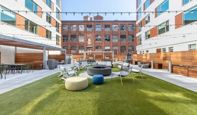 a view of a patio with couches table and chairs and potted plants