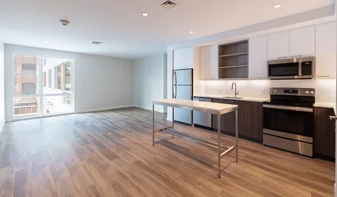a kitchen with stainless steel appliances a stove a sink and a refrigerator