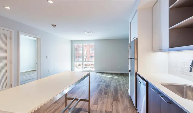 a kitchen with a wooden floor and a wooden floor