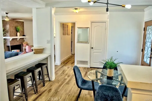 a dining room with furniture and wooden floor