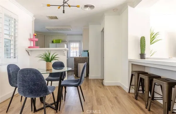 a dining room with furniture and wooden floor