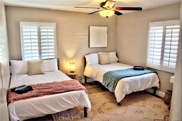 a bedroom with a bed two lamps and a window