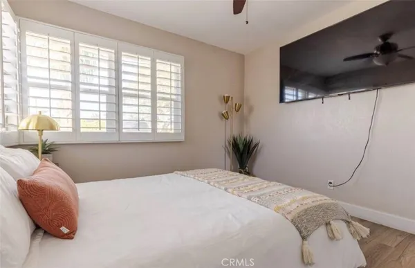 a bedroom with a bed and a window