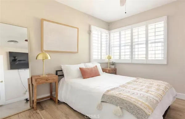 a bedroom with a bed a couch and a window