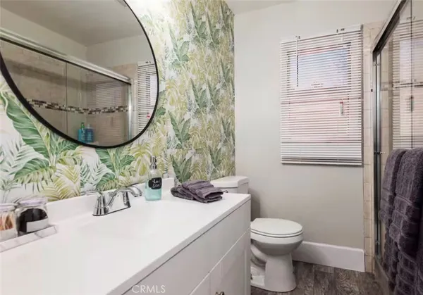 a bathroom with a sink mirror toilet and vanity