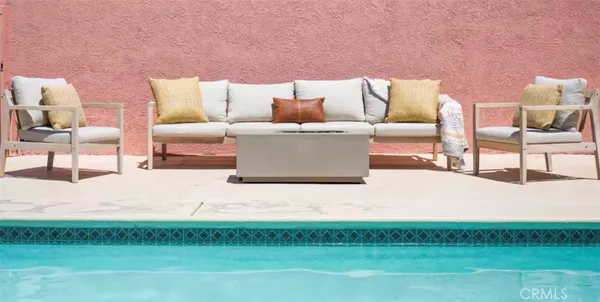 a backyard of a house with a table and chairs
