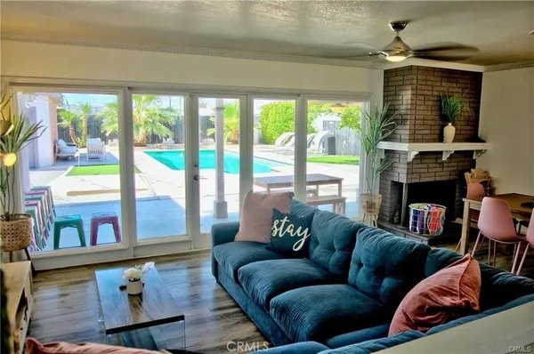 a living room with fireplace furniture and a floor to ceiling window