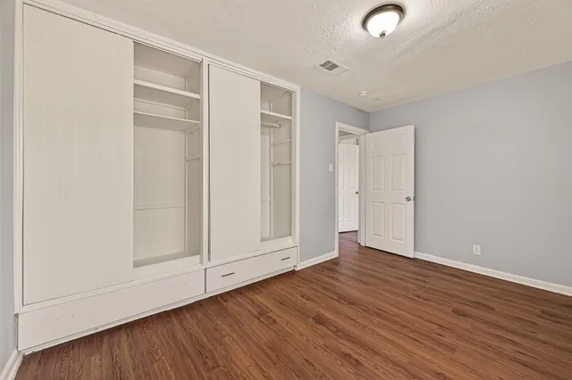 an empty room with wooden floor