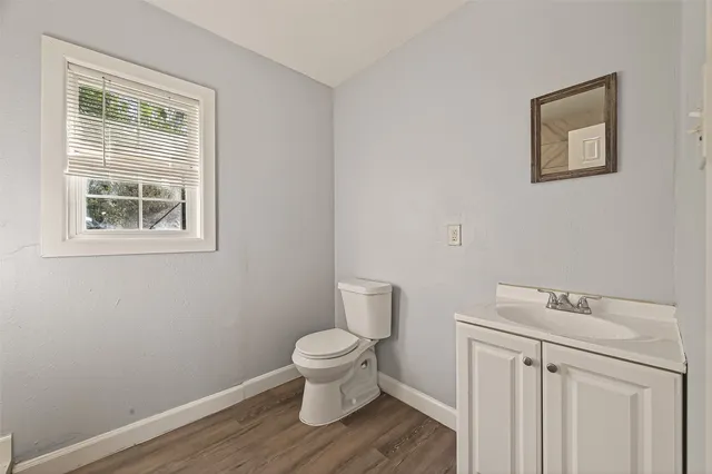 a white toilet sitting next to a bathroom sink