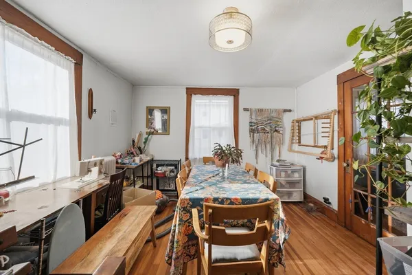 a view of a dining room with furniture window and wooden floor