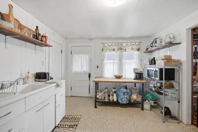 a kitchen with a refrigerator and a sink