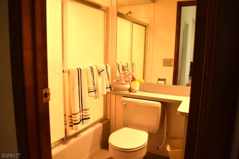 27 3rd Avenue Roseland, NJ 07068 - Photo 12 of 16 a bathroom with a sink a toilet and a large window