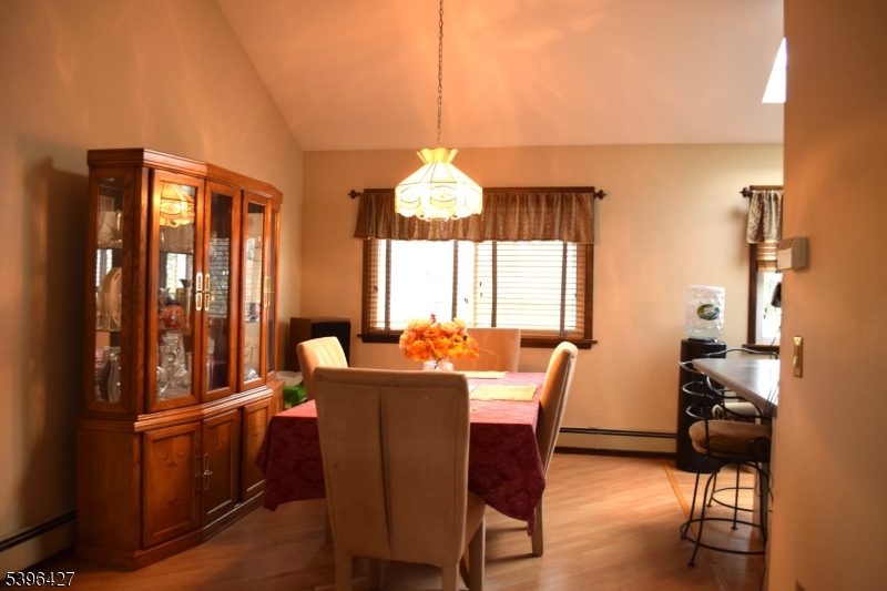 27 3rd Avenue Roseland, NJ 07068 - Photo 3 of 16 a view of dining room and livingroom with furniture wooden floor a chandelier