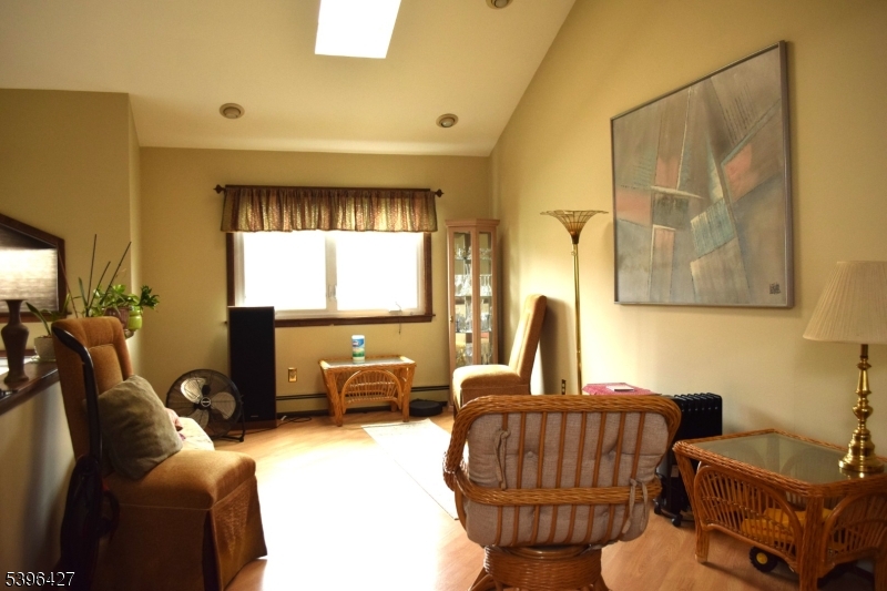 27 3rd Avenue Roseland, NJ 07068 - Photo 4 of 16 a living room with furniture fireplace and a large window