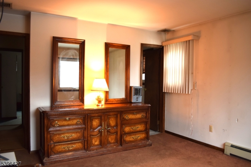 27 3rd Avenue Roseland, NJ 07068 - Photo 7 of 16 a bathroom with a sink a mirror and a window