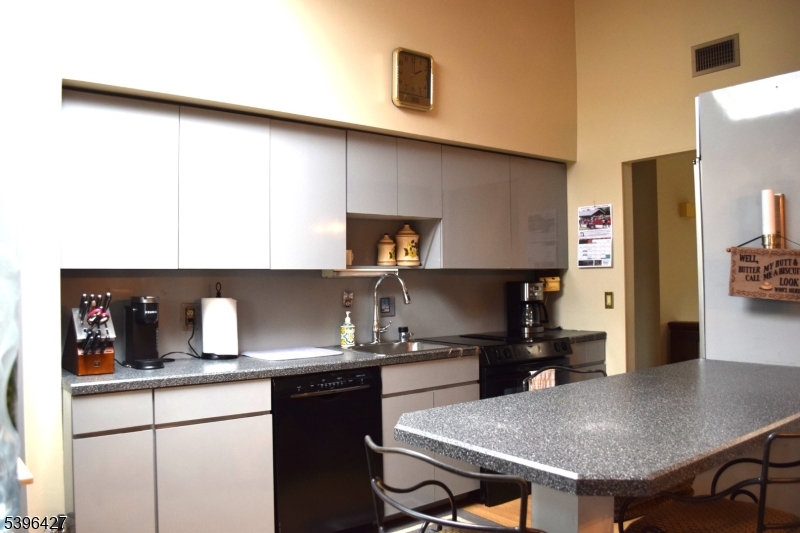 27 3rd Avenue Roseland, NJ 07068 - Photo 9 of 16 a kitchen with a sink cabinets and wooden floor