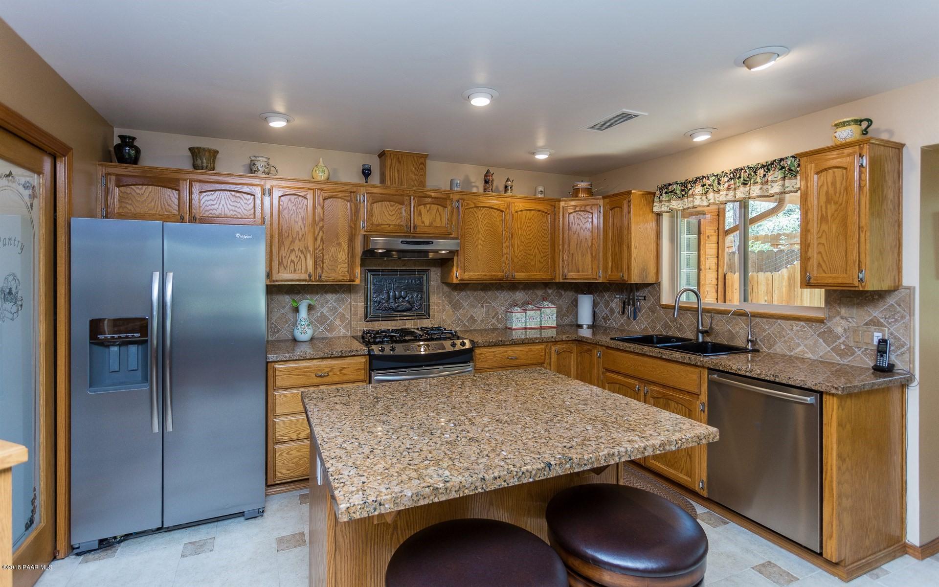 1631 Kaibab Loop Prescott, AZ 86303 - Photo 11 of 45 a kitchen with stainless steel appliances granite countertop a sink stove and refrigerator