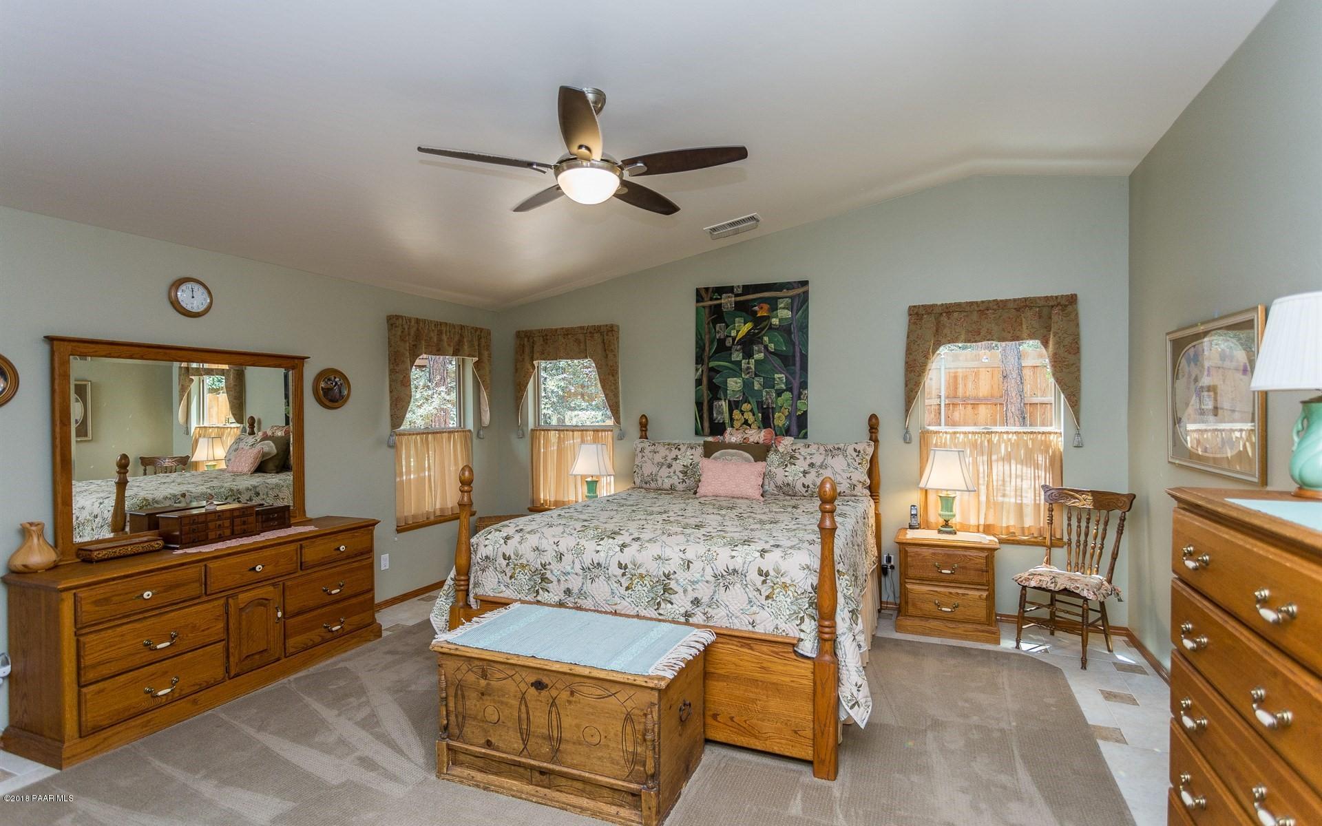 1631 Kaibab Loop Prescott, AZ 86303 - Photo 13 of 45 a bedroom with a bed and wooden floor