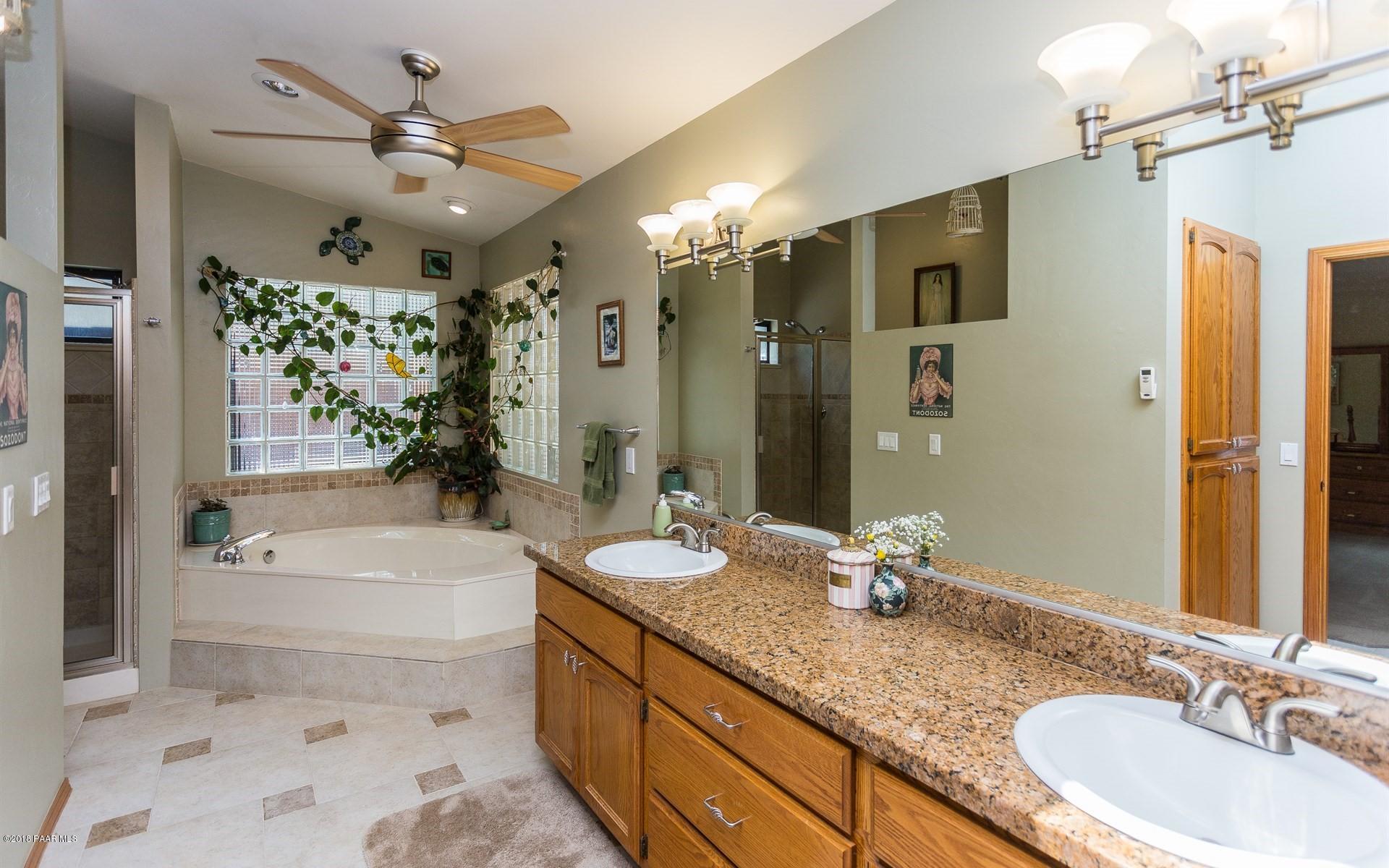1631 Kaibab Loop Prescott, AZ 86303 - Photo 14 of 45 a bathroom with a granite countertop tub sink double vanity granite tub shower and a mirror