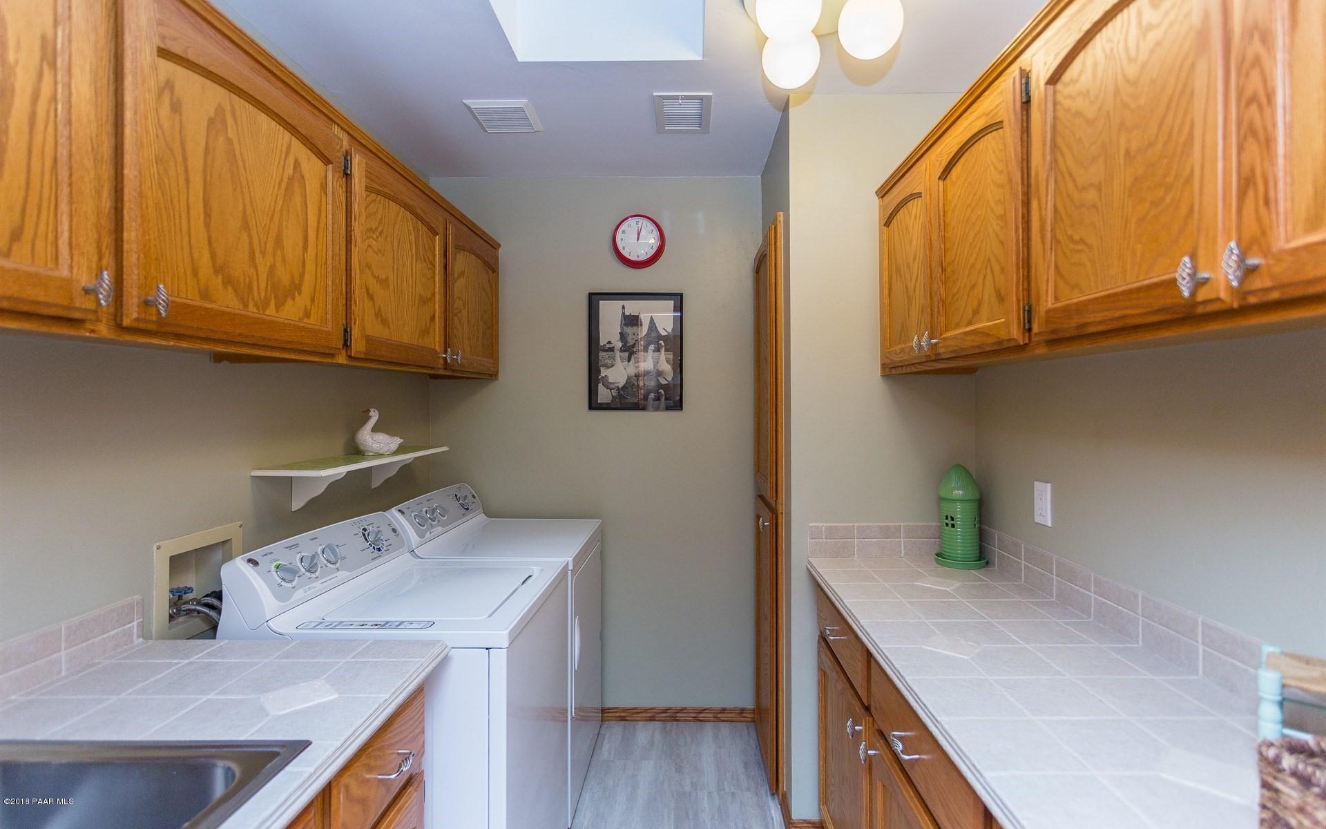 1631 Kaibab Loop Prescott, AZ 86303 - Photo 23 of 45 a kitchen with cabinets and wooden floor