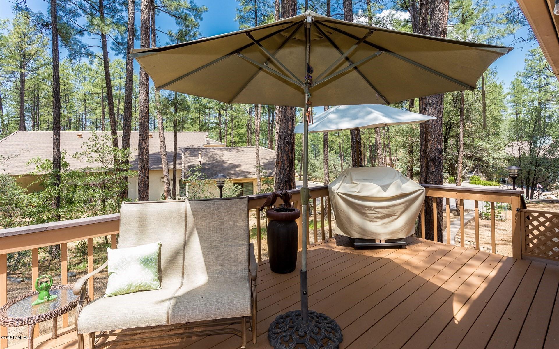 1631 Kaibab Loop Prescott, AZ 86303 - Photo 24 of 45 a table and chair under an umbrella