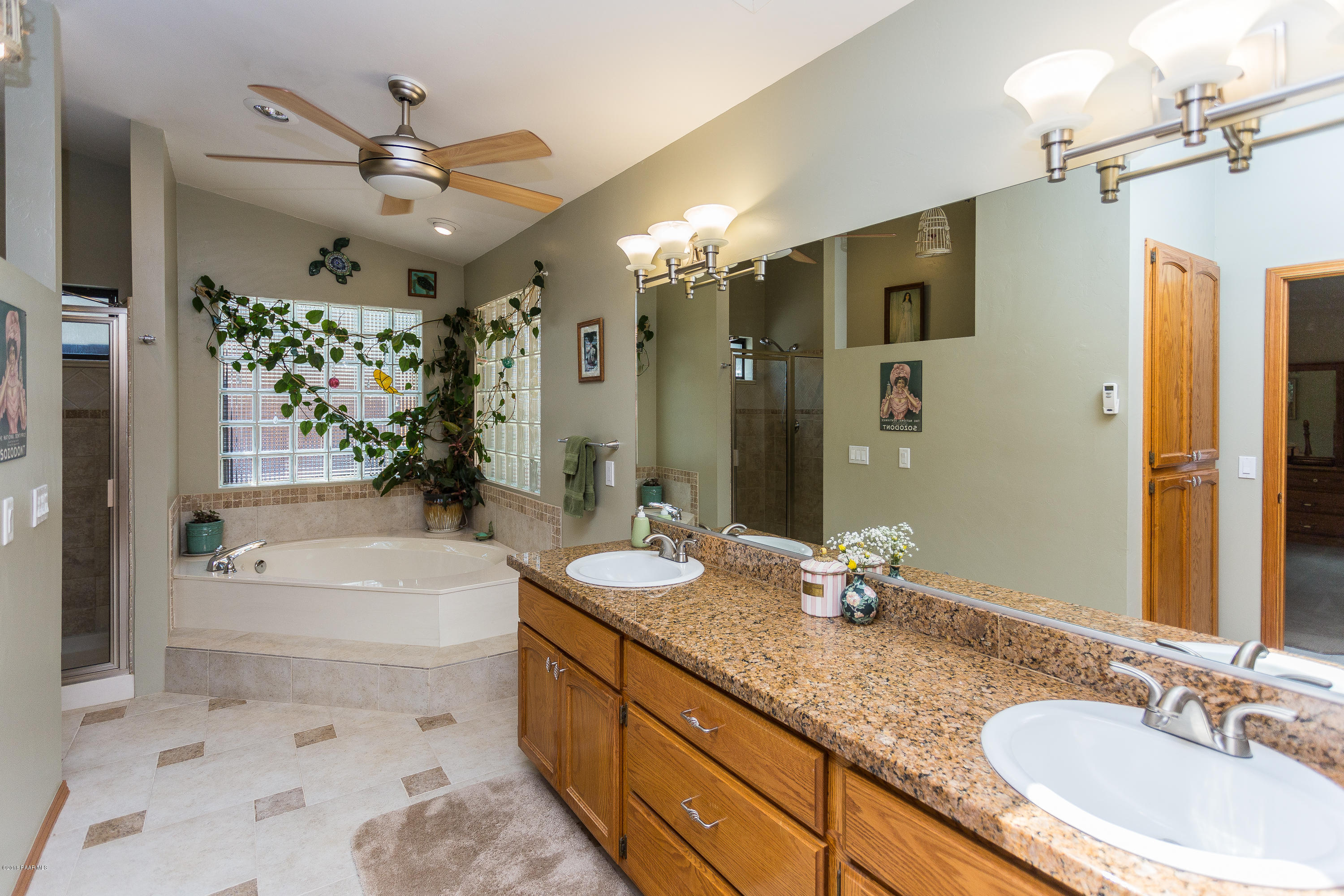 1631 Kaibab Loop Prescott, AZ 86303 - Photo 28 of 45 a bathroom with a granite countertop tub sink double vanity granite tub shower and mirror