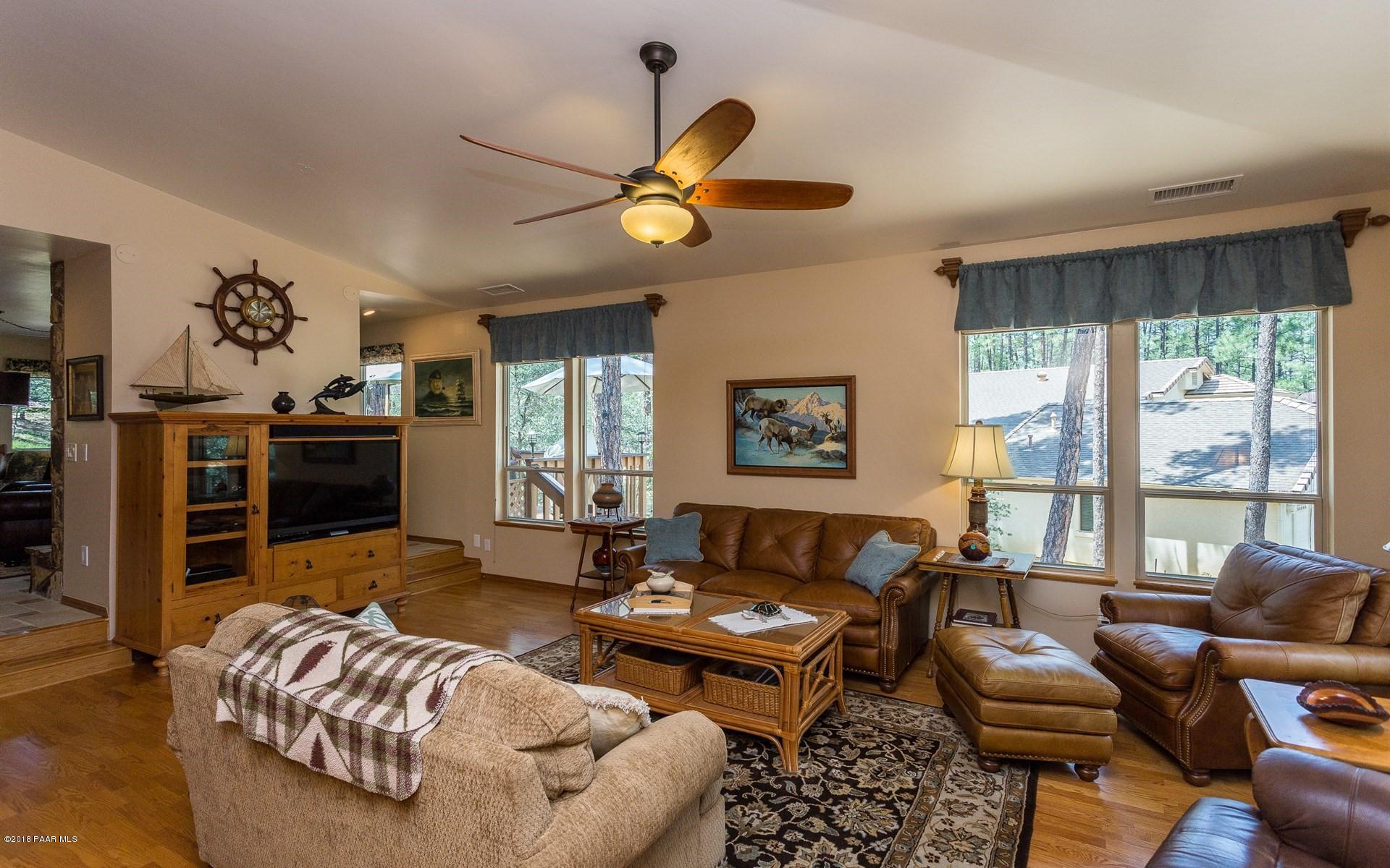 1631 Kaibab Loop Prescott, AZ 86303 - Photo 4 of 45 a living room with furniture a fireplace and a large window