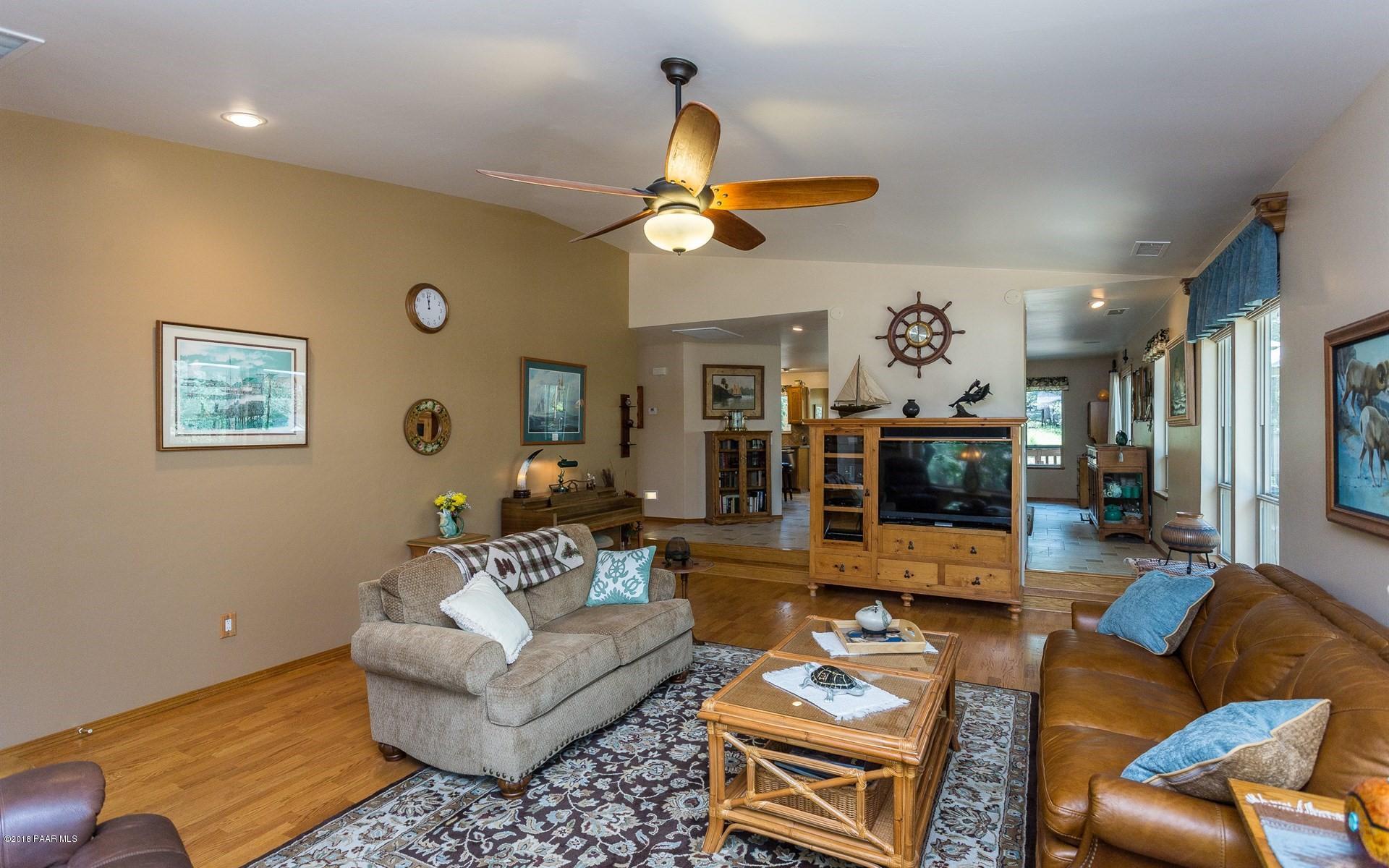 1631 Kaibab Loop Prescott, AZ 86303 - Photo 6 of 45 a living room with furniture a rug and a chandelier