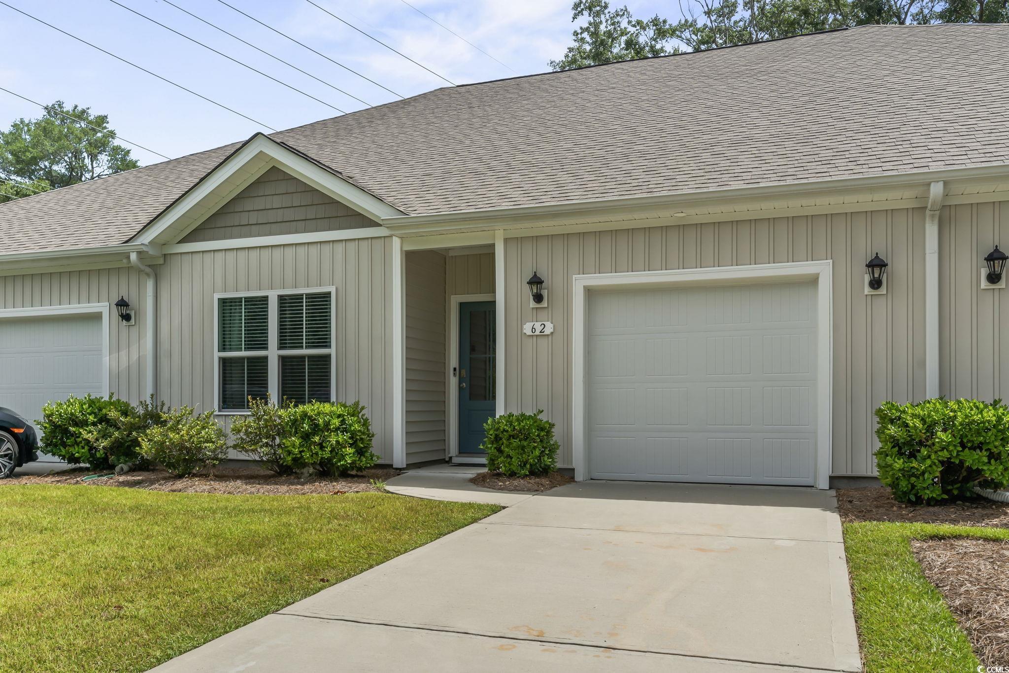 62 Sea Shell Drive, Unit 62 Murrells Inlet, SC 29576 - Photo 13 of 34 View of front of home featuring roof with shingles, an attached garage, and a front lawn