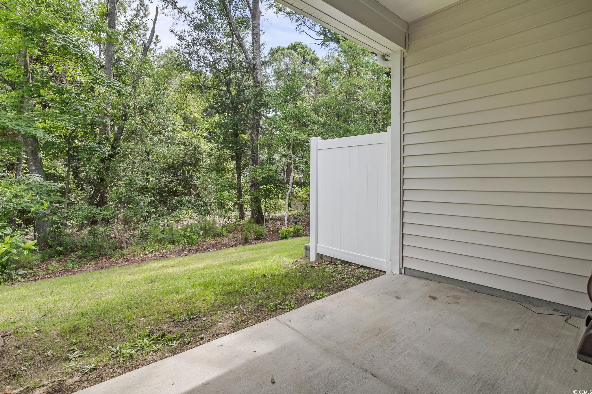 62 Sea Shell Drive, Unit 62 Murrells Inlet, SC 29576 - Photo 14 of 34 View of green lawn with a patio area