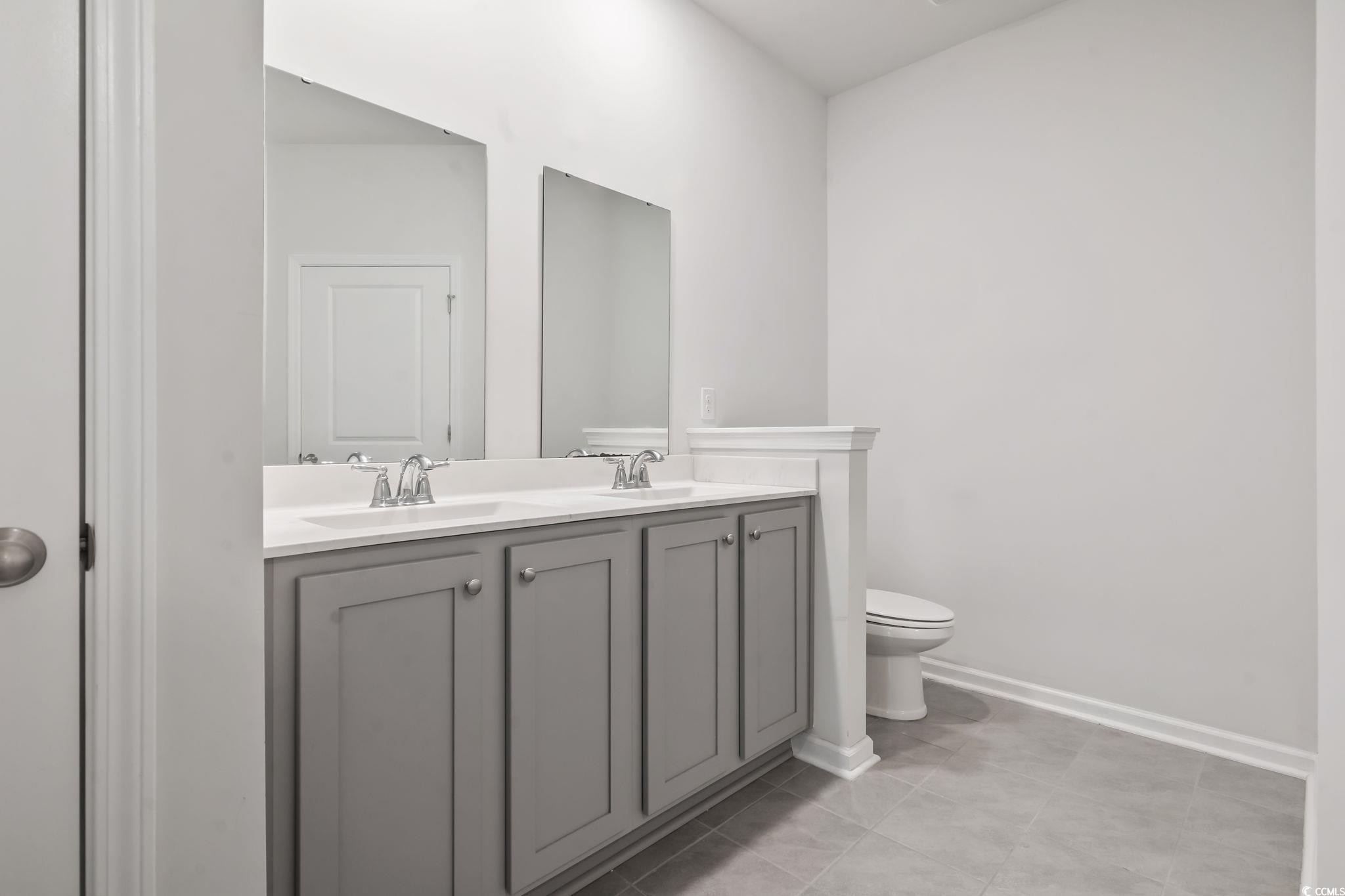 62 Sea Shell Drive, Unit 62 Murrells Inlet, SC 29576 - Photo 16 of 34 Bathroom with double vanity and tile patterned flooring