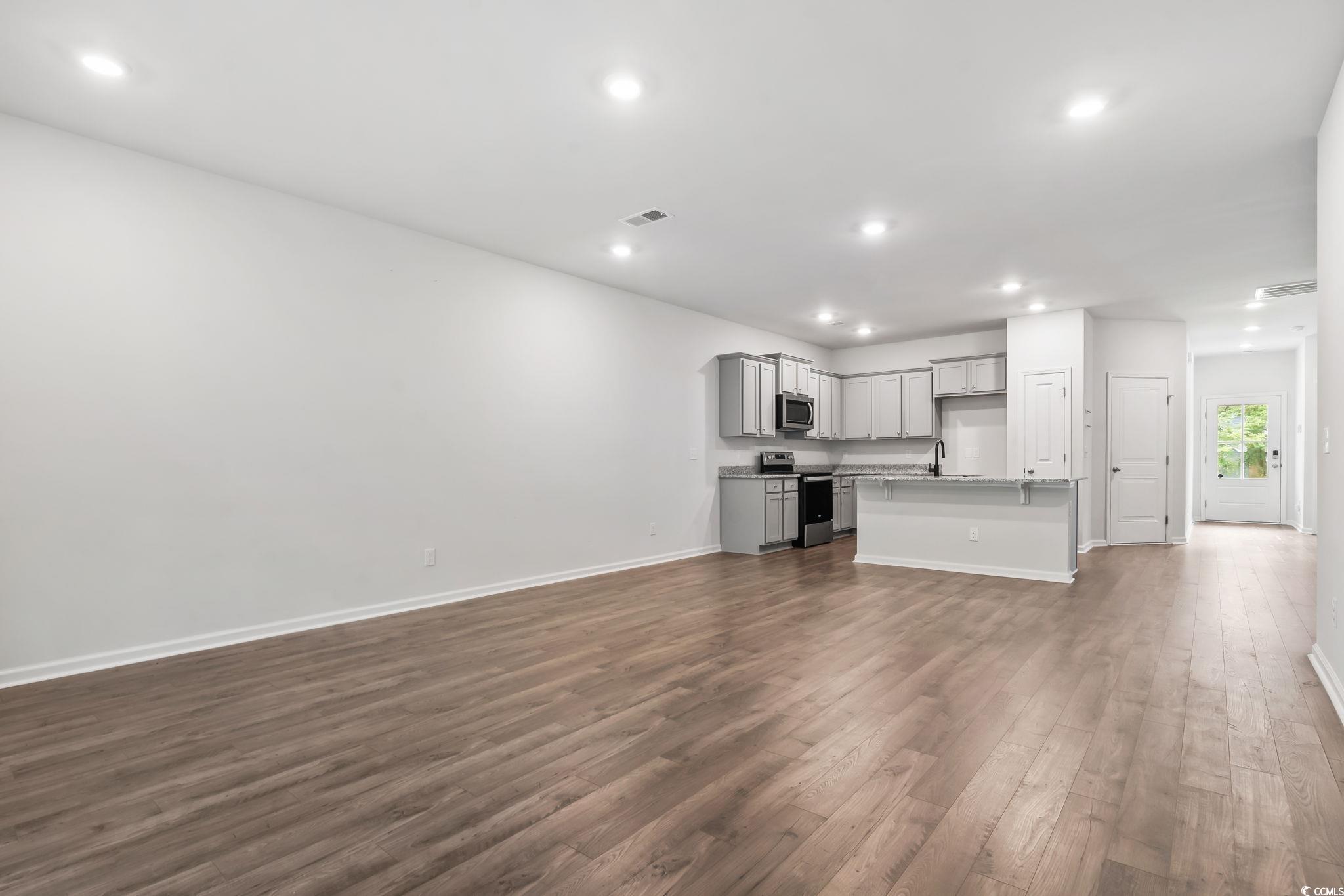 62 Sea Shell Drive, Unit 62 Murrells Inlet, SC 29576 - Photo 21 of 34 Unfurnished living room with dark wood-type flooring and recessed lighting