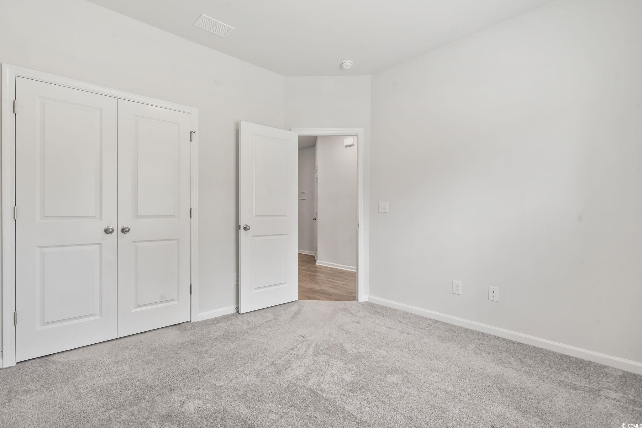 62 Sea Shell Drive, Unit 62 Murrells Inlet, SC 29576 - Photo 24 of 34 Unfurnished bedroom with carpet floors and a closet