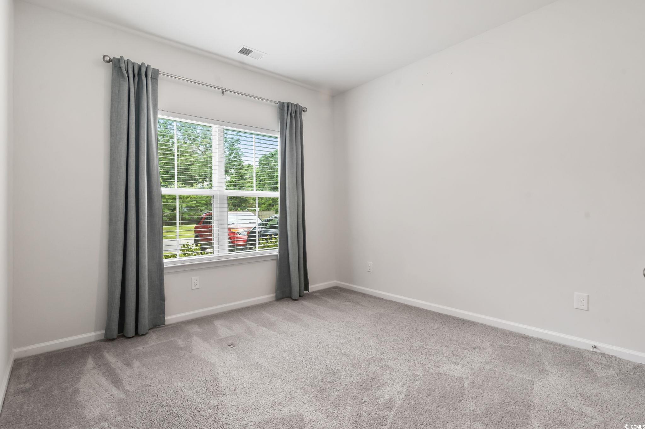 62 Sea Shell Drive, Unit 62 Murrells Inlet, SC 29576 - Photo 25 of 34 Unfurnished room with carpet floors and baseboards