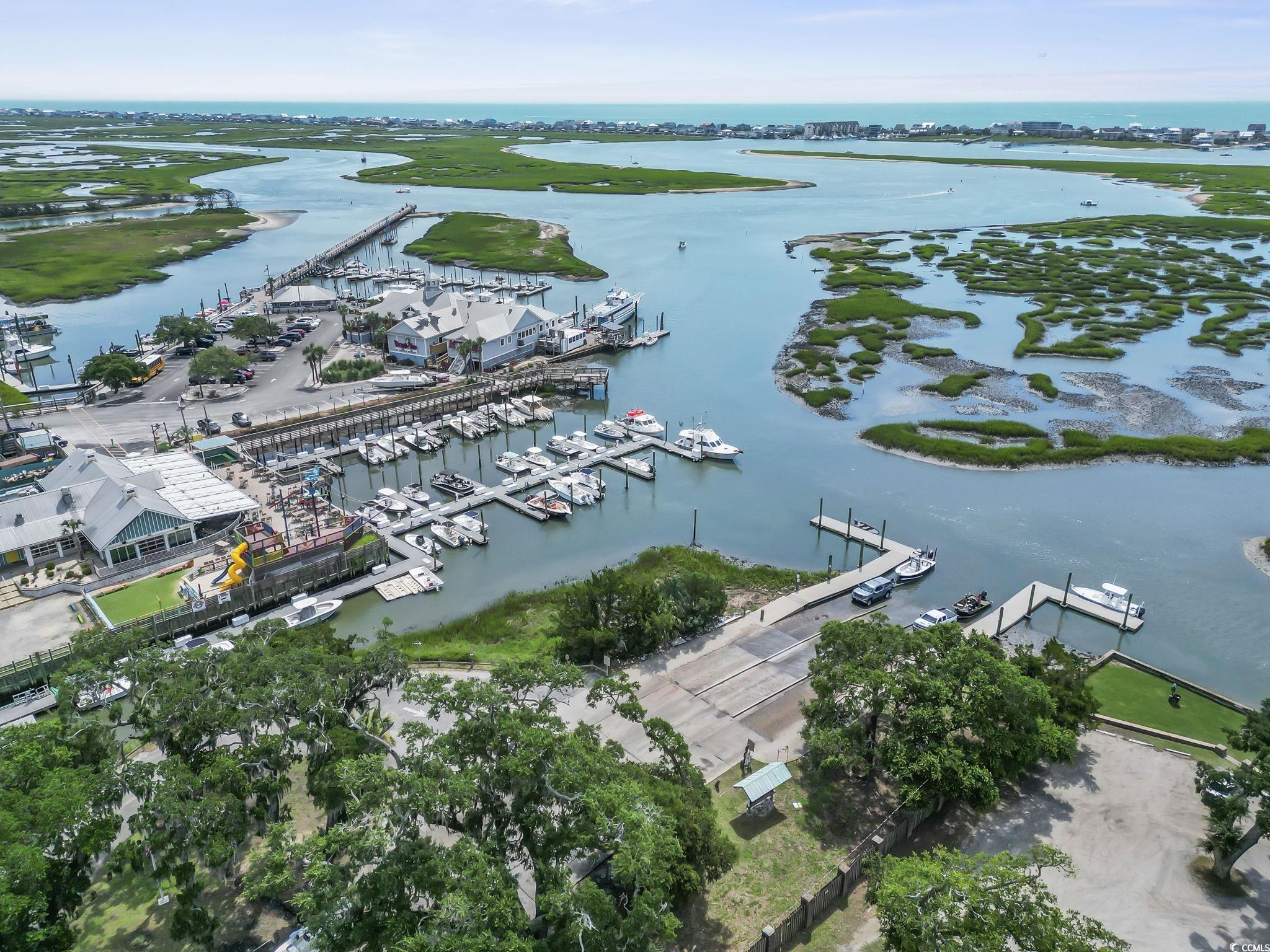 62 Sea Shell Drive, Unit 62 Murrells Inlet, SC 29576 - Photo 28 of 34 Drone / aerial view of a nearby body of water and numerous boat docks