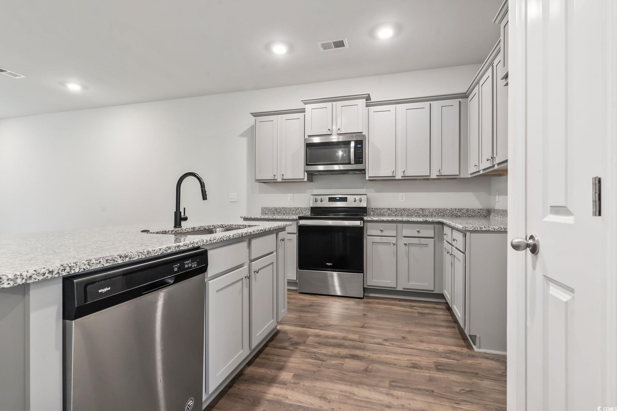 62 Sea Shell Drive, Unit 62 Murrells Inlet, SC 29576 - Photo 4 of 34 Kitchen featuring appliances with stainless steel finishes, dark wood-style flooring, gray cabinetry, and recessed lighting