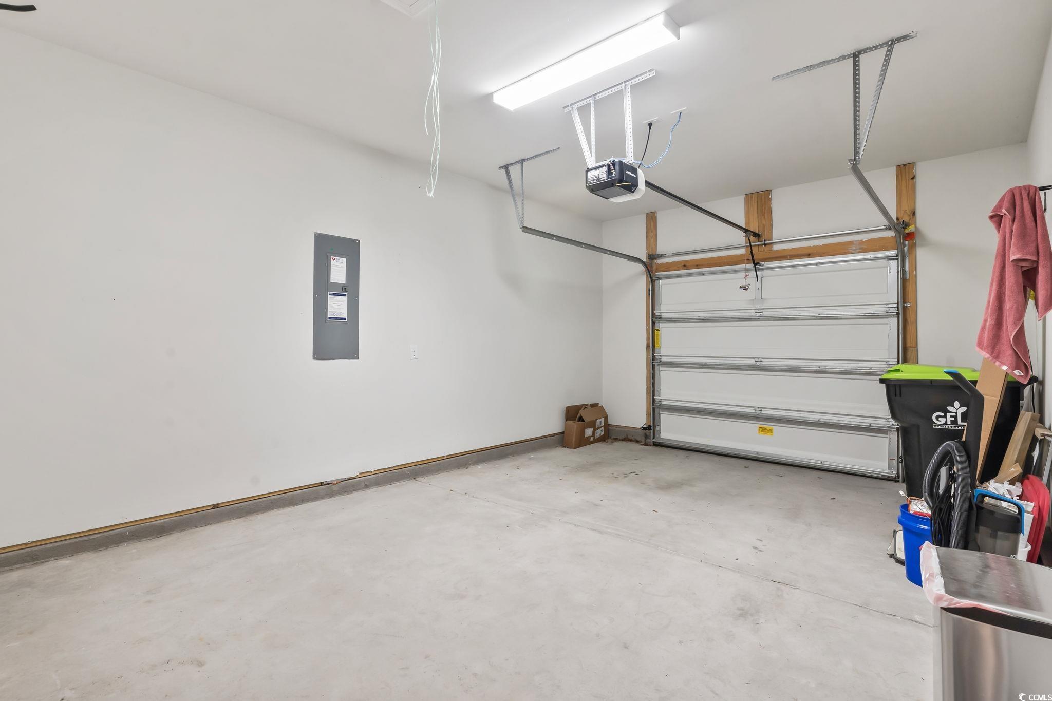 62 Sea Shell Drive, Unit 62 Murrells Inlet, SC 29576 - Photo 8 of 34 Garage with a garage door opener and electric panel
