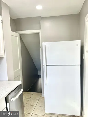 a view of kitchen with refrigerator and microwave