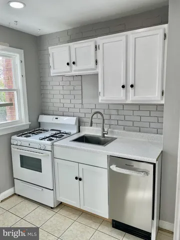a kitchen with cabinets appliances and a sink