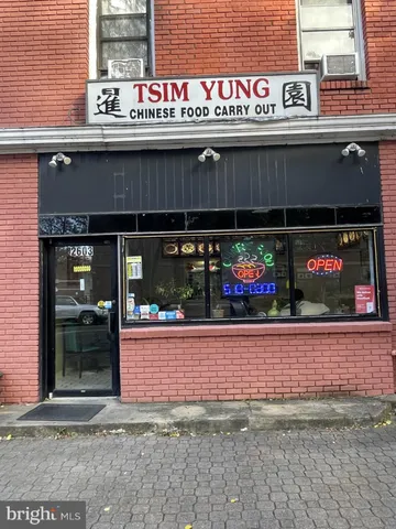 a front view of a building with sitting area