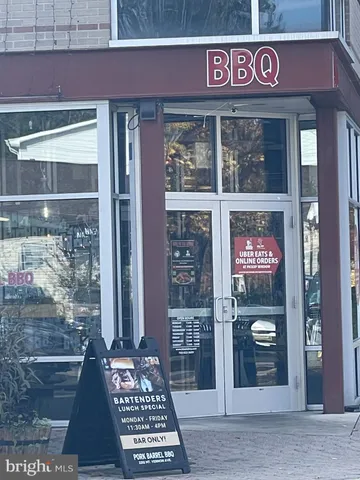 a view of a brick house with large windows and a tree